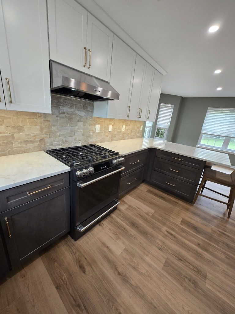 Range wall with dark lower cabinets and stone backsplash - LR Contracting, Sadsburyville PA
