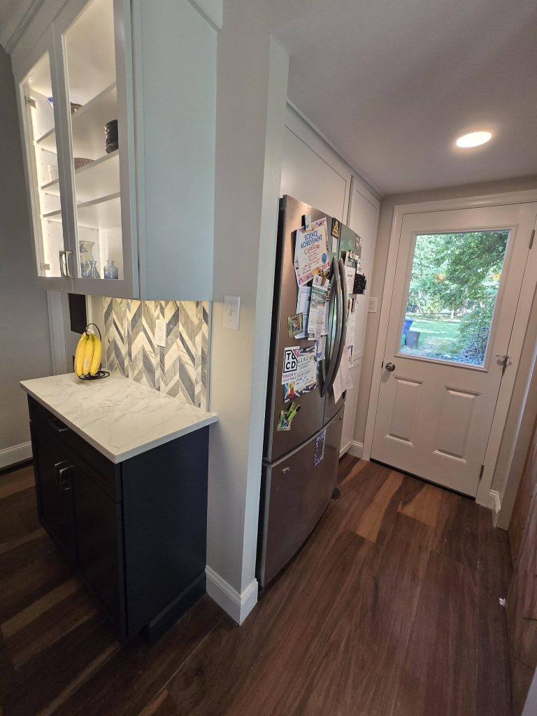 Glass-front cabinets and marble backsplash by the rear entry door - LR Contracting, Downingtown PA