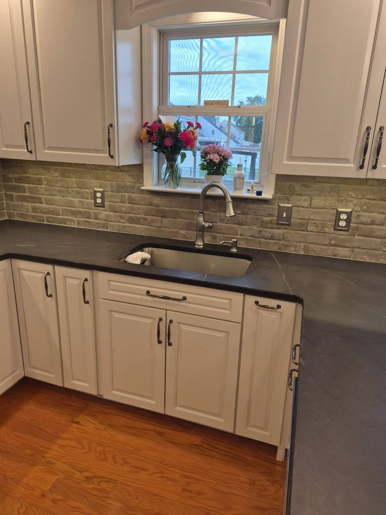 Sink under the window with stone backsplash - LR Contracting, Limerick PA